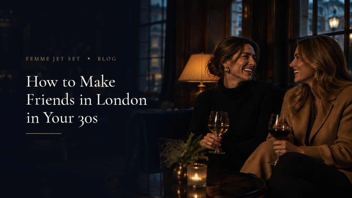 Two elegant women in their thirties laughing over glasses of wine in a lamplit London members' bar, How to Make Friends in London in Your 30s cover