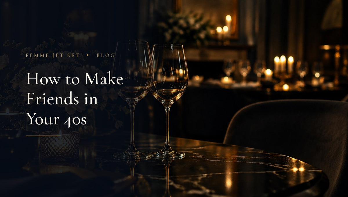 Two crystal wine glasses and white flowers on dark marble by candlelight, suggesting an intimate dinner among friends, Friends in Your 40s cover