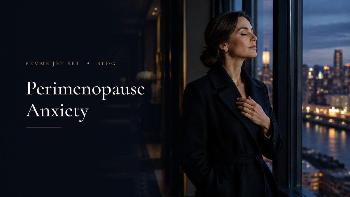 Composed woman in her forties in a black wool coat taking a calm breath by a tall window overlooking city lights at dusk, Perimenopause Anxiety cover